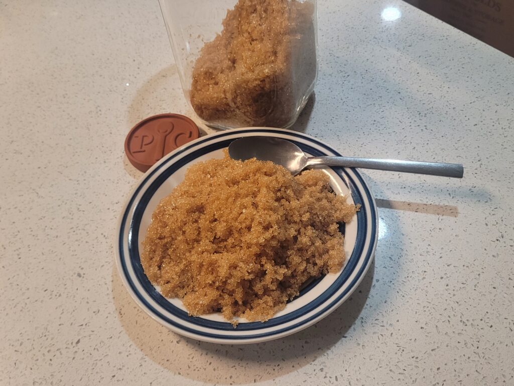 Homemade Brown sugar on a plate storing into a jar