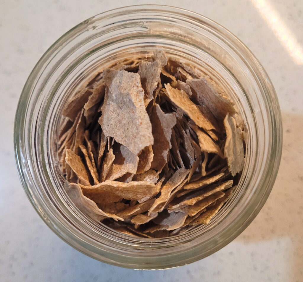 Dehydrated Sourdough Starter Close up a jar filled with large flakes of sourdough starter