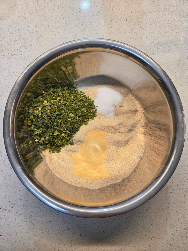 Mix Together Dry Ingredients - Sourdough Cheddar and Chive Bread.jpg a bowl of flour with a pile of chives, salt and garlic powder