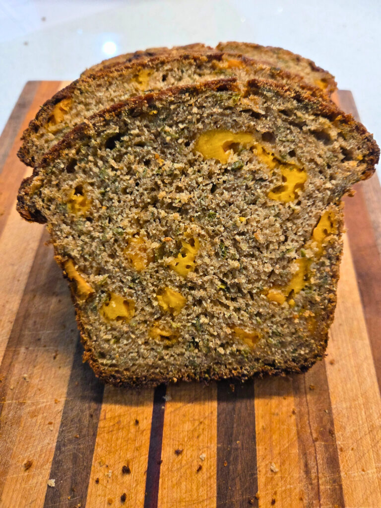 Slice of Bread - Sourdough Cheddar and Chive Bread.jpg a close up picture of a sourdough cheddar and chive slice of bread