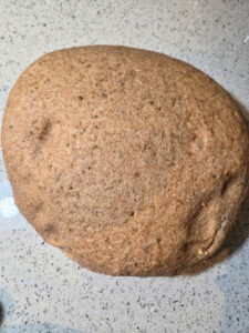 a ball of dough with a dimple on the left side